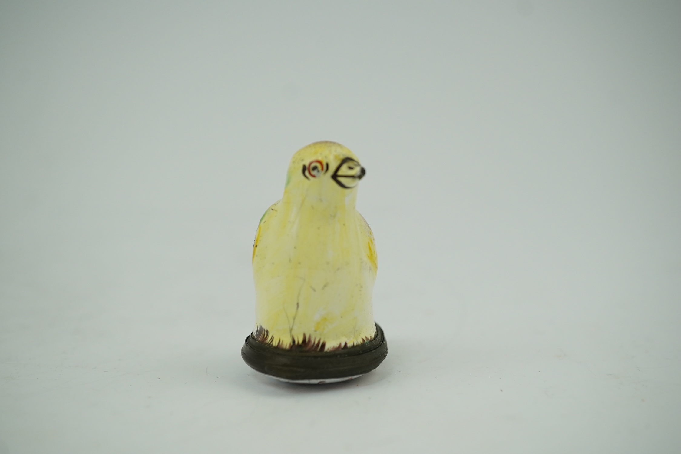 An 18th century South Staffordshire (Bilston) enamel box modelled as a canary with floral decorated lid, 4.5cm high. Condition - fair/poor